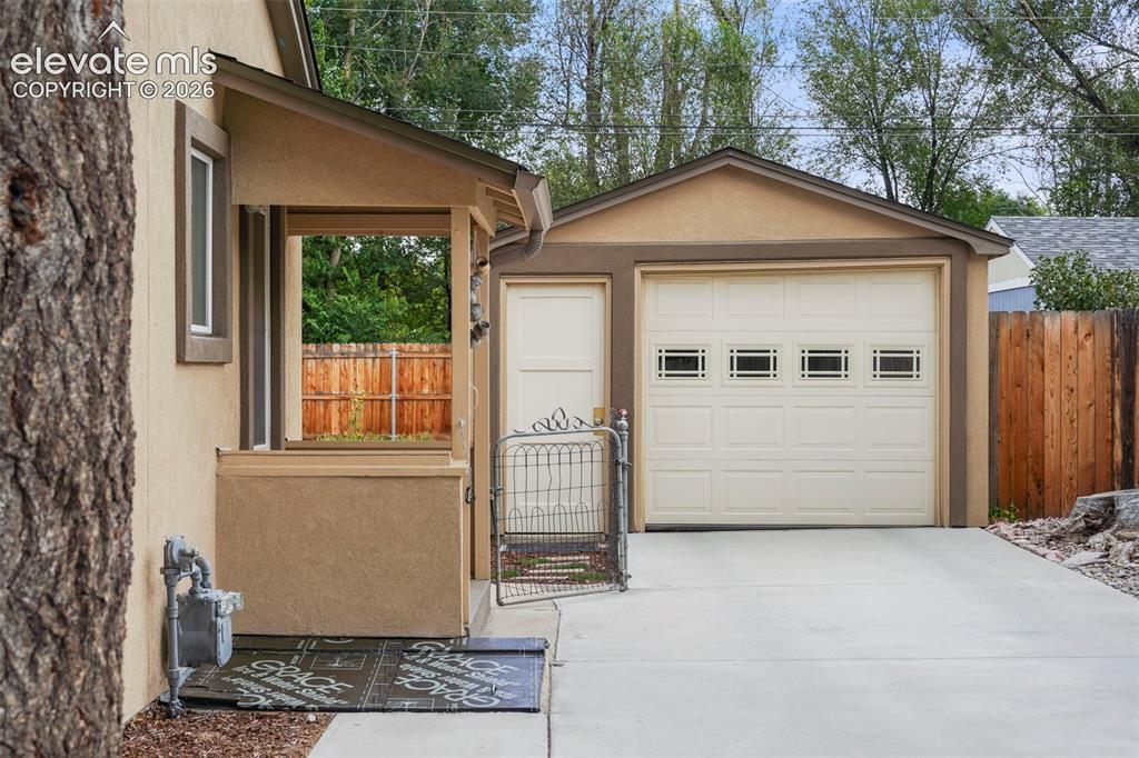 Image 17 of 23: Garage with long driveway offers plenty of parking