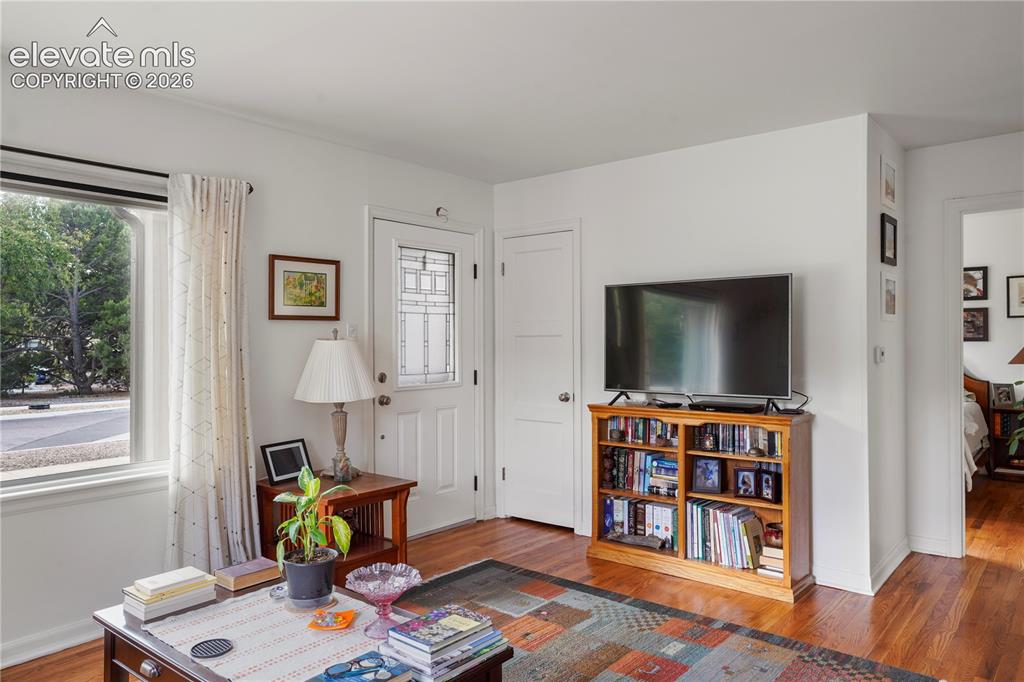 Image 4 of 23: Warm, inviting living room with Hardwood floor