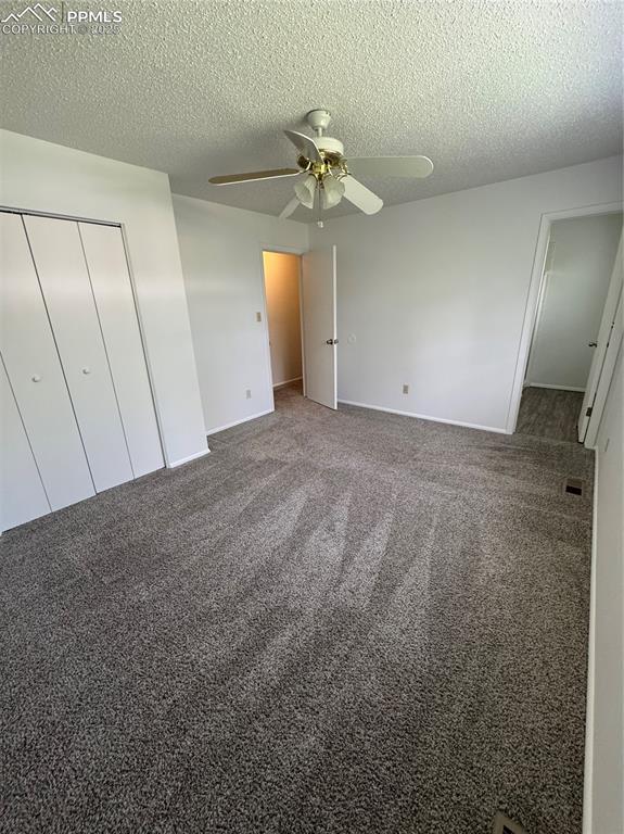 Image 8 of 13: Unfurnished bedroom featuring a textured ceiling, carpet flooring, ceiling