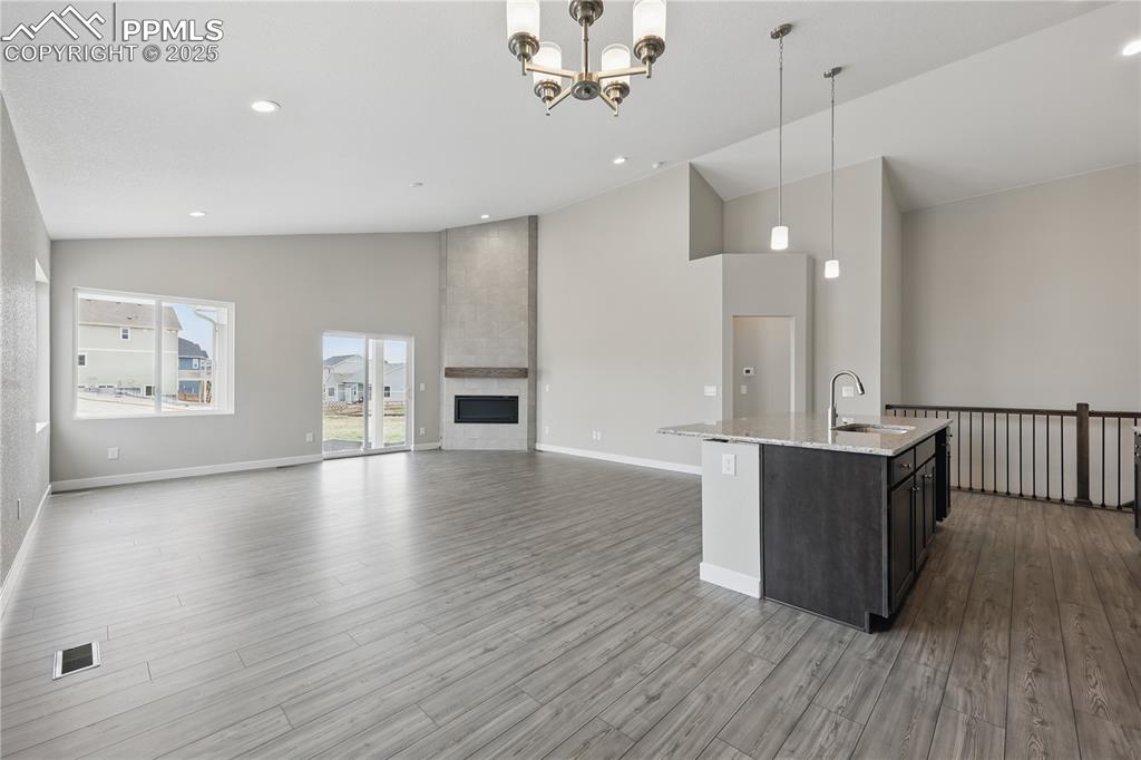 Image 7 of 25: Dining area with hanging light fixtures, high vaulted ceiling, open floor p