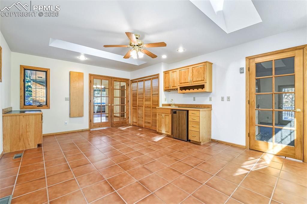 Image 41 of 50: Huge extra Flex room with walk out to backyard deck and built in cabinets a