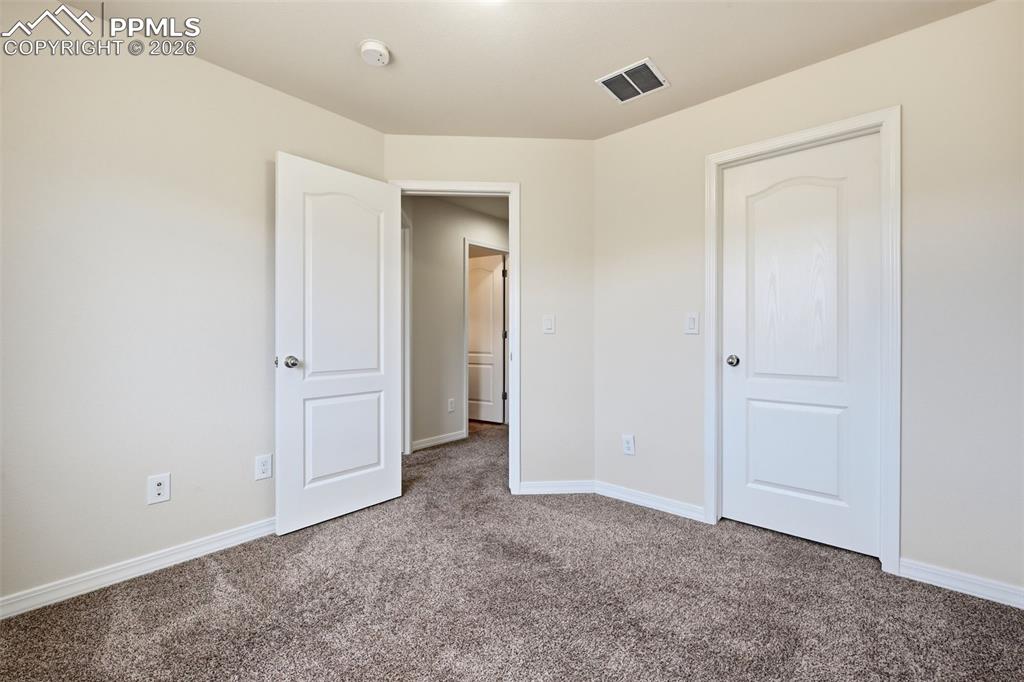 Image 16 of 28: Comfortable bedroom #2 with walk-in closet and flexible use potential.