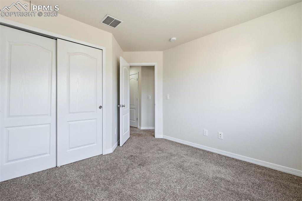 Image 18 of 28: Additional bedroom offers flexibility for guests or remote work.