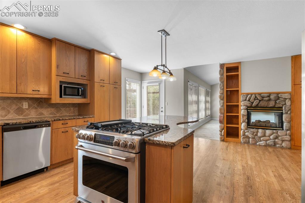 Image 12 of 35: Kitchen featuring stainless steel appliances, light wood finished floors, d