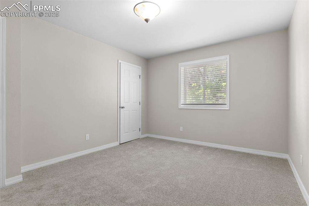 Image 27 of 35: Bedroom featuring light colored carpet