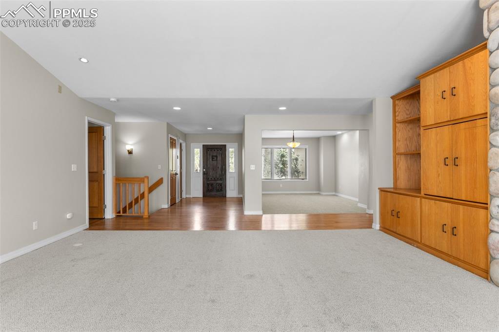 Image 7 of 35: Great room with carpet flooring and recessed lighting