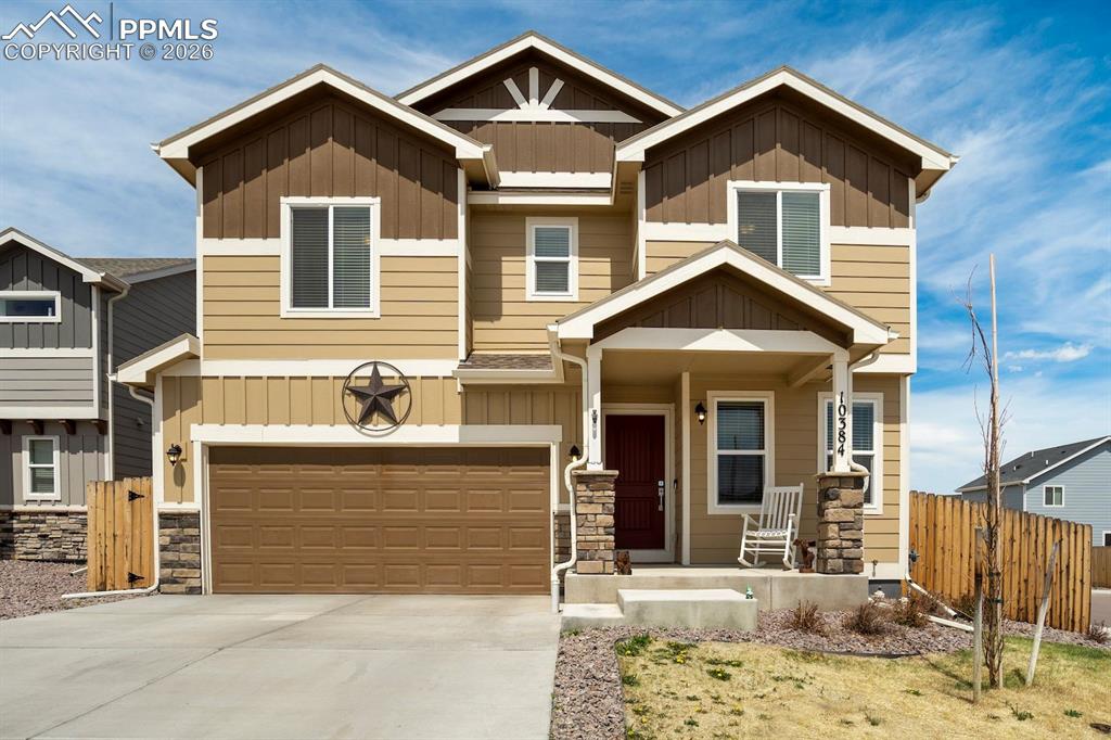 Image 1 of 46: Craftsman-style home with board and batten siding, covered porch, stone sid