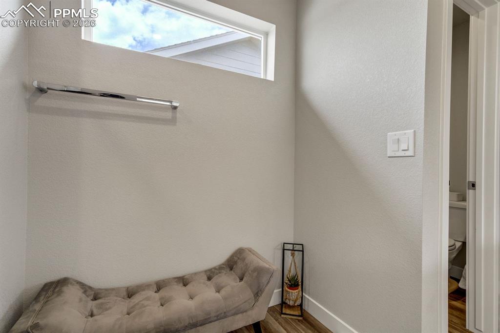Image 26 of 45: Living area with wood finished floors and baseboards