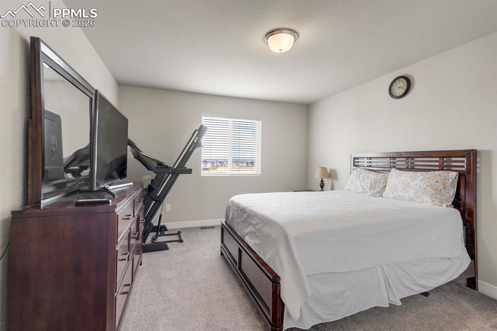 Image 27 of 45: Bedroom featuring light colored carpet and baseboards