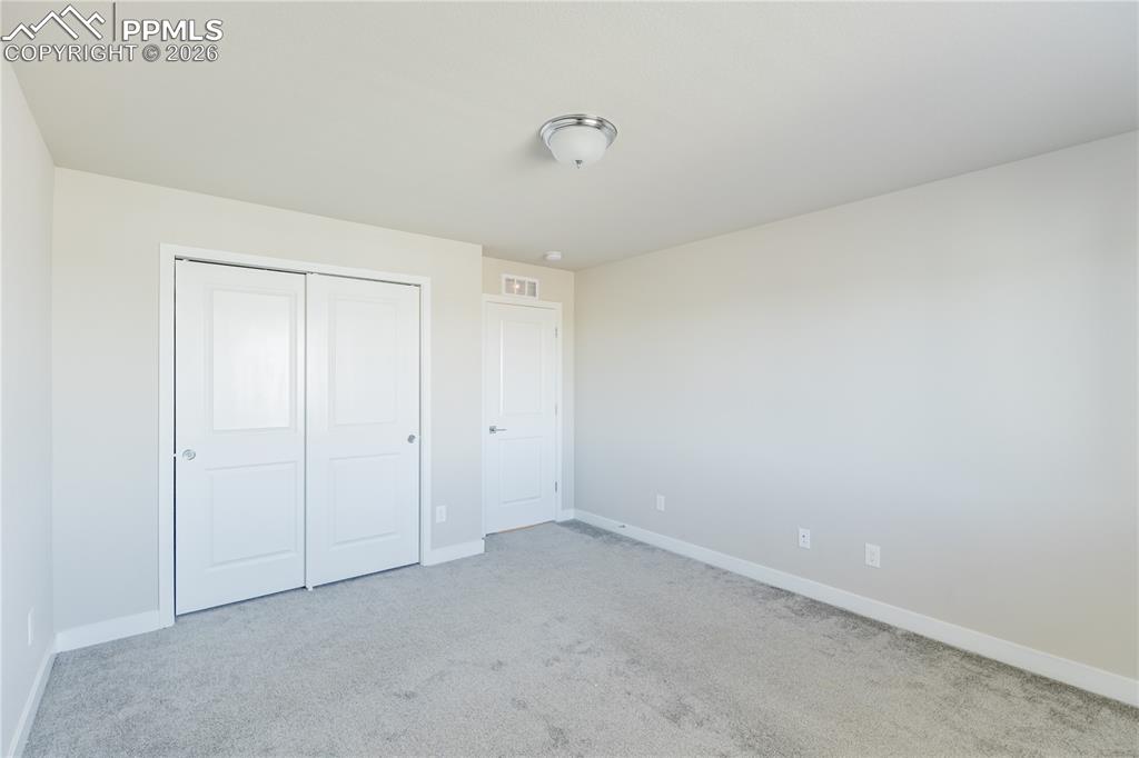 Image 34 of 46: Unfurnished bedroom featuring light carpet and a closet