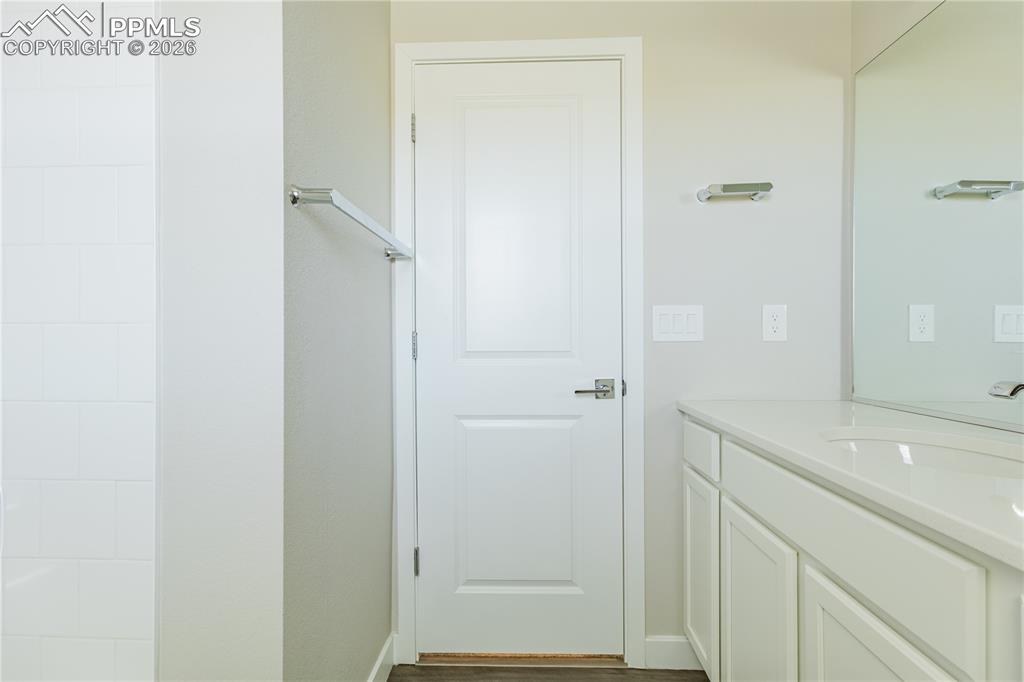 Image 37 of 46: Bathroom with vanity and dark wood-style flooring