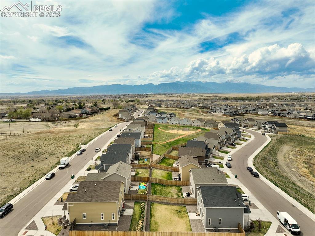 Image 43 of 46: Aerial view of residential area featuring mountains