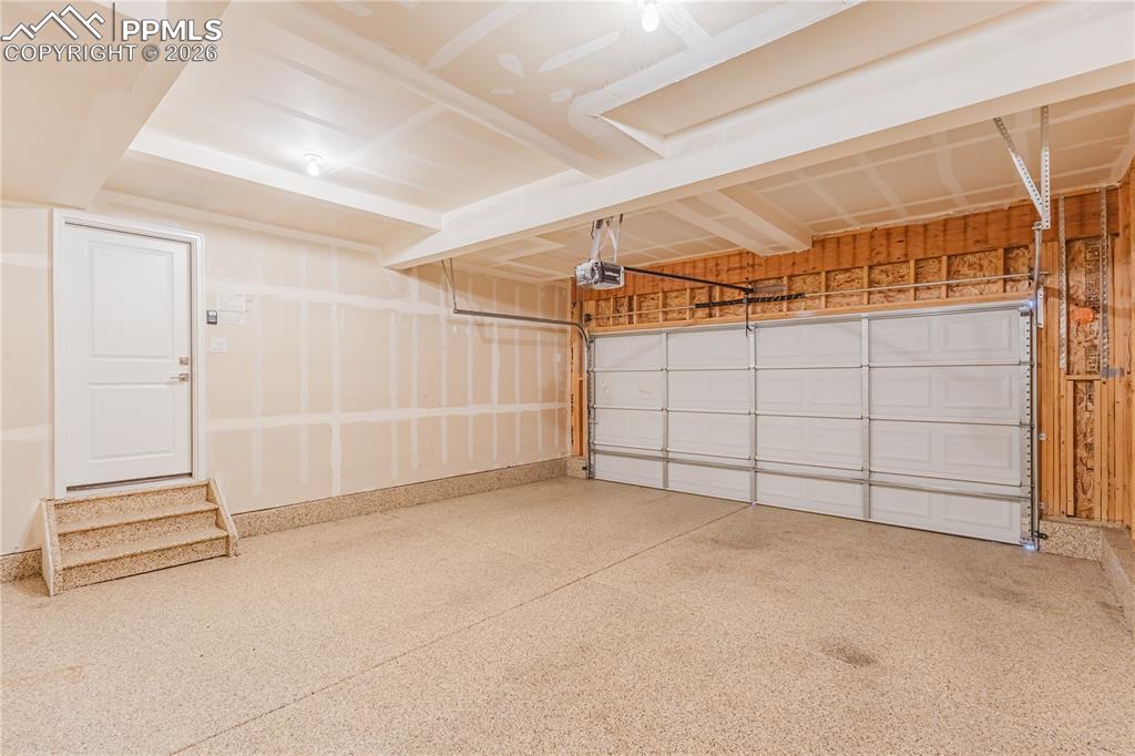 Image 45 of 46: Garage with epoxied floor & garage door opener