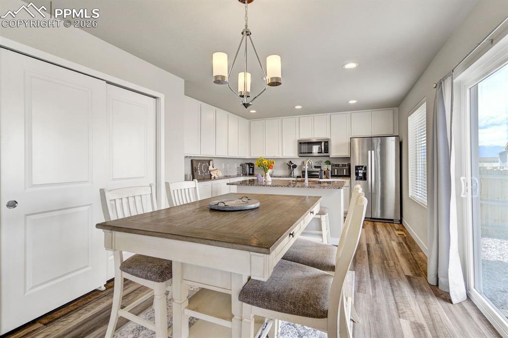 Image 7 of 46: Dining space featuring light wood-style floors, recessed lighting, and a ch