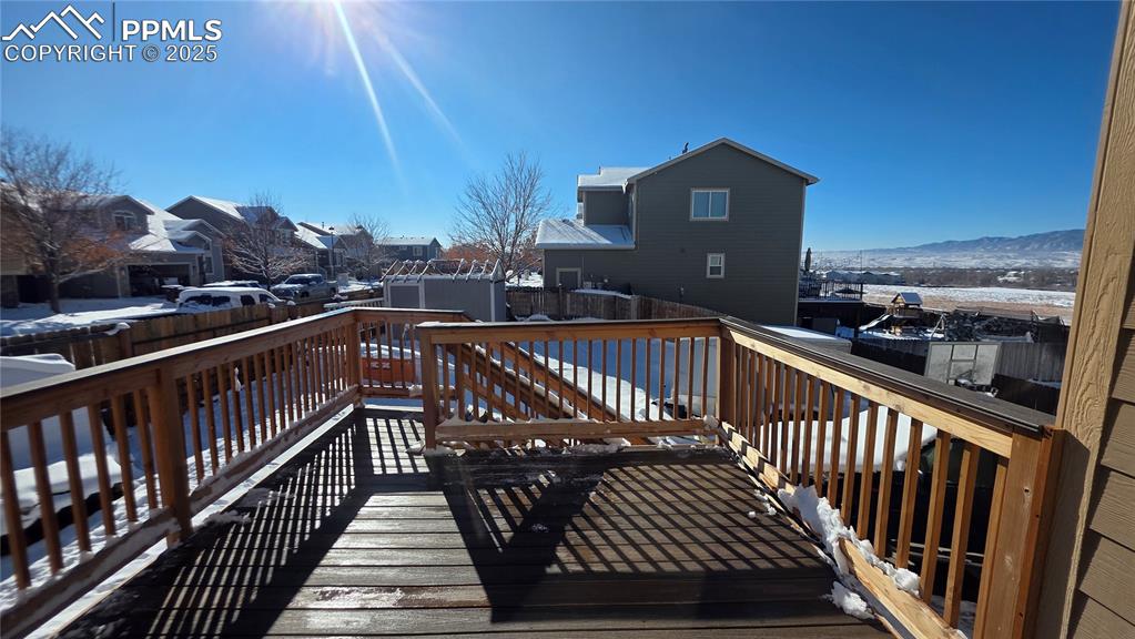 Image 14 of 34: Covered deck with a fully fanced backyard view. 