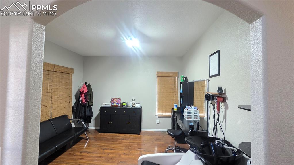 Image 3 of 34: Office area featuring arched walkways, dark wood-type flooring,