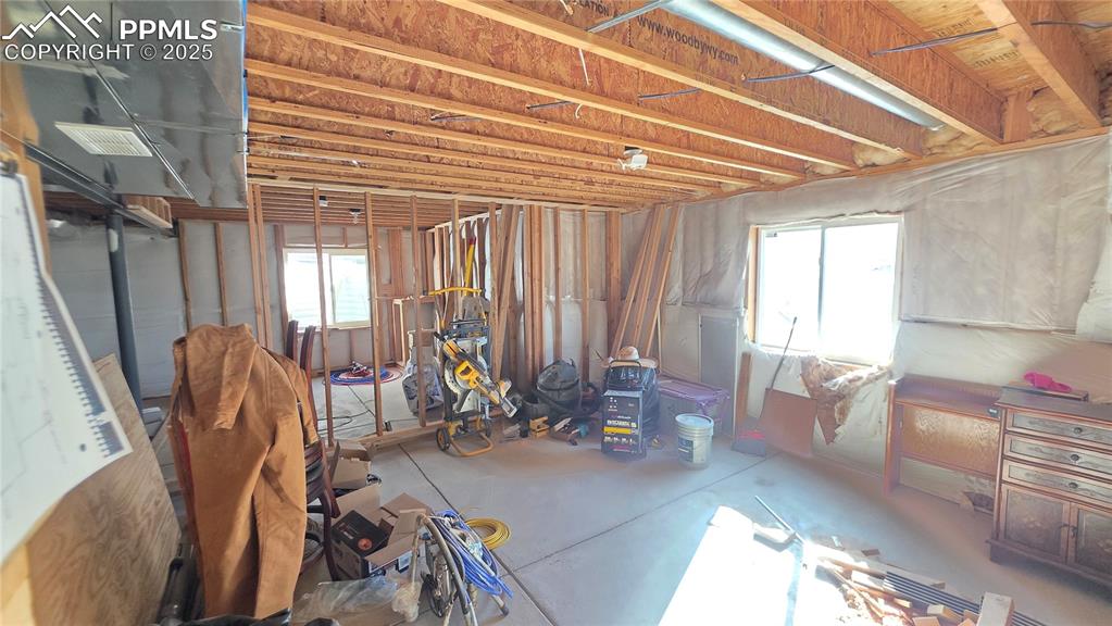 Image 30 of 34: Miscellaneous room with plenty of natural light and concrete floors