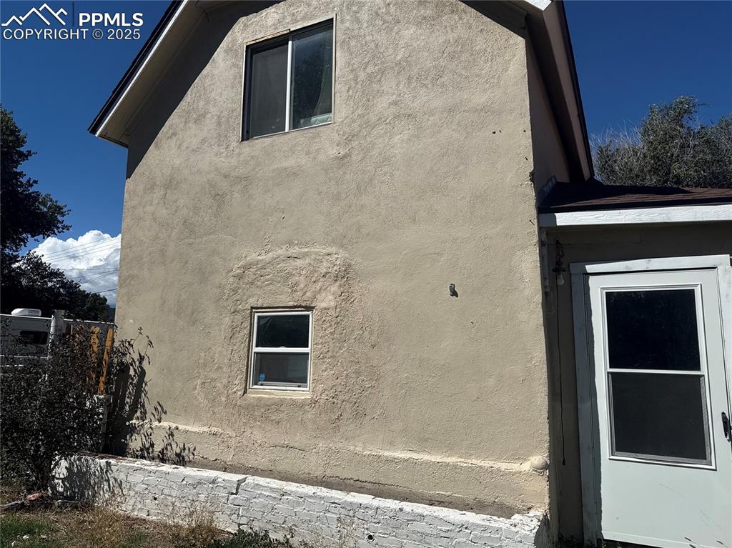 Image 13 of 14: View of property exterior featuring stucco siding