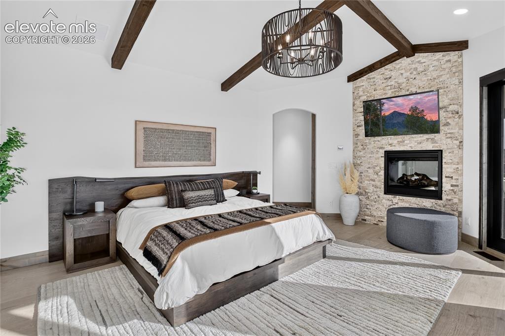 Image 12 of 50: Main level primary suite w/ walk-out & dual sided fireplace