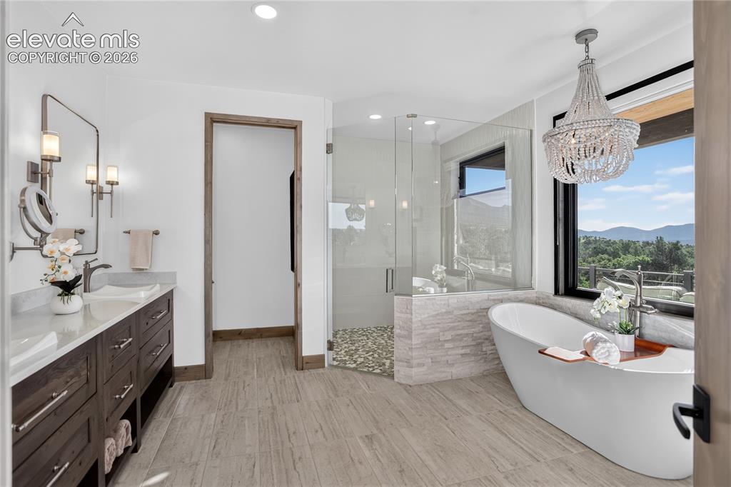 Image 13 of 50: Primary bath w/ mountain views & walk-in shower