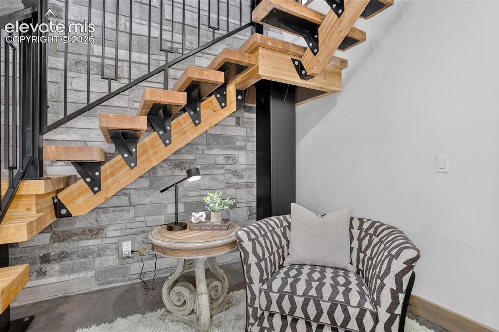 Image 23 of 50: Reading nook under floating staircase