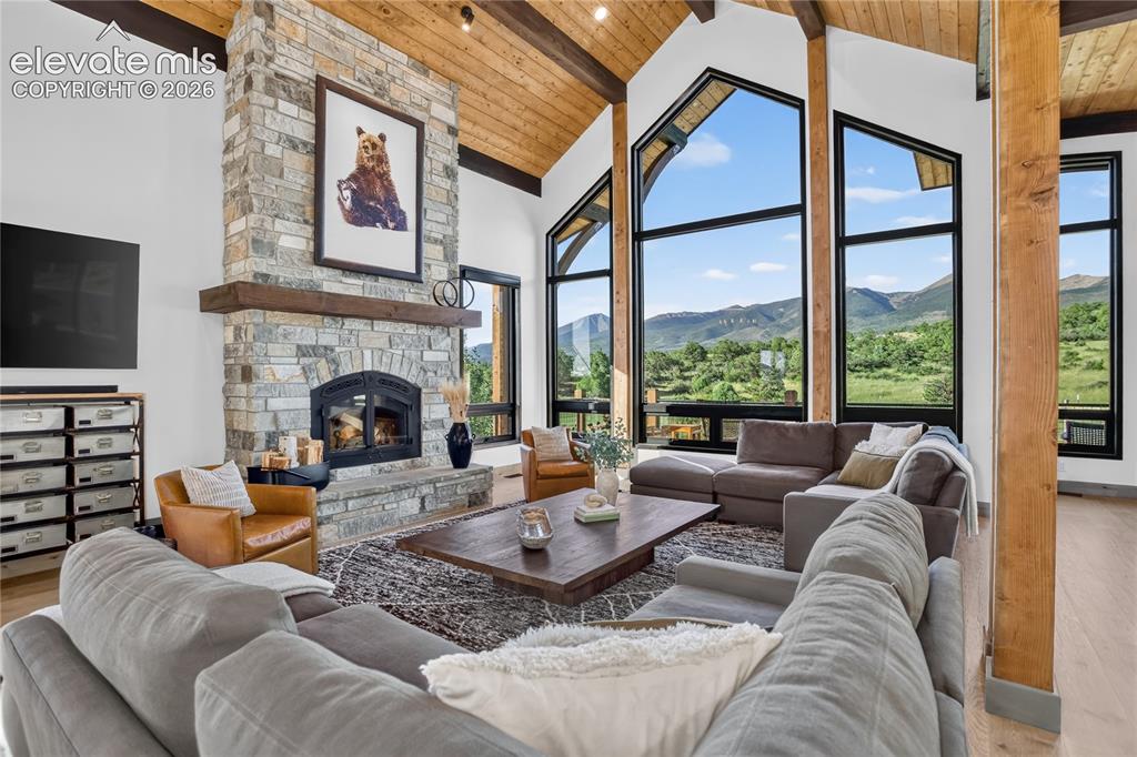 Image 4 of 50: Living room with Sangre de Cristo views & woodburning fireplace