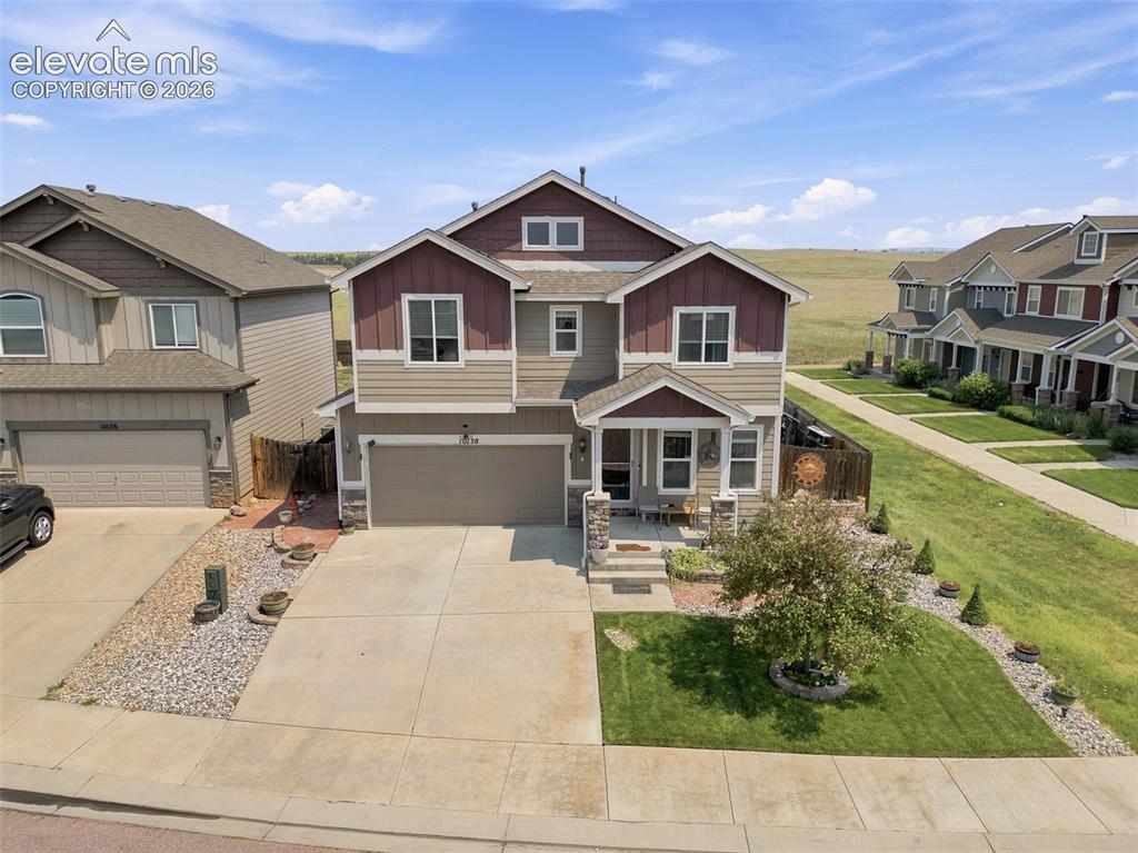 Image 1 of 30: Two-story residence featuring a two-car garage, covered porch entry, and a