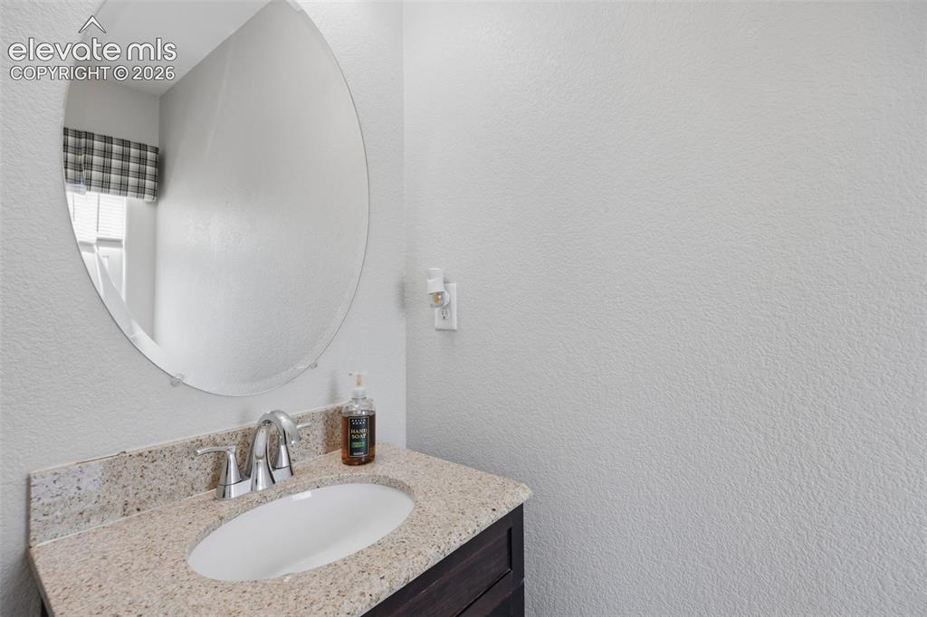 Image 11 of 30: Double vanity with integrated sinks and chrome fixtures