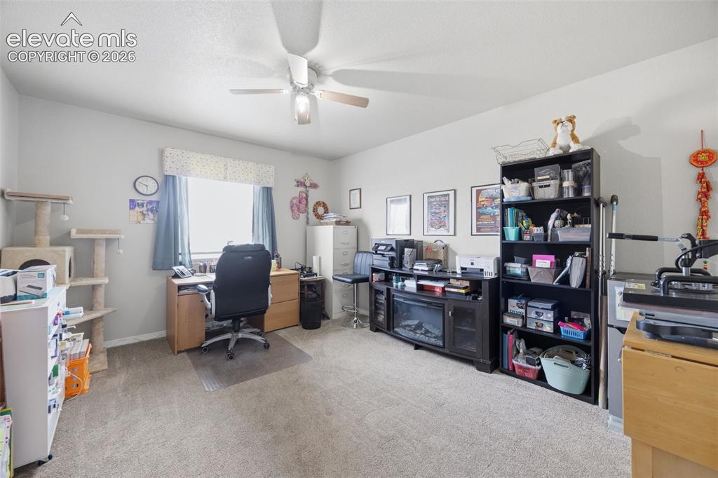 Image 19 of 30: Neutral-toned walls complement wood-finish flooring in this room featuring