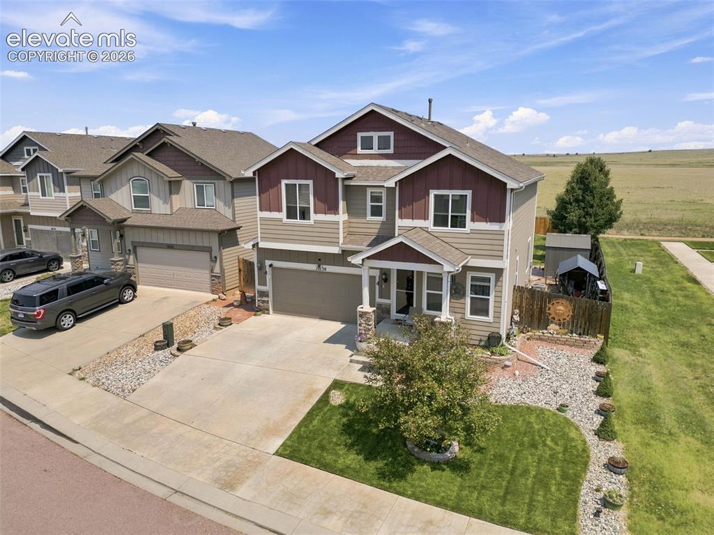 Image 2 of 30: Two-story residence featuring a covered front porch, attached two-car garag