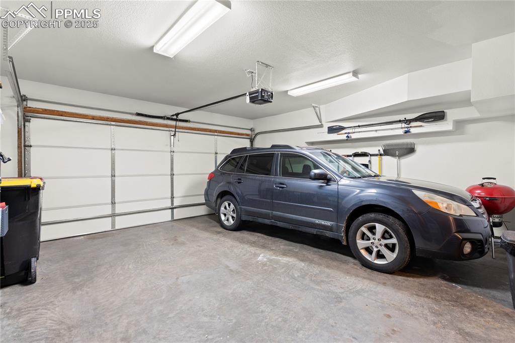 Image 12 of 40: Garage with a garage door opener