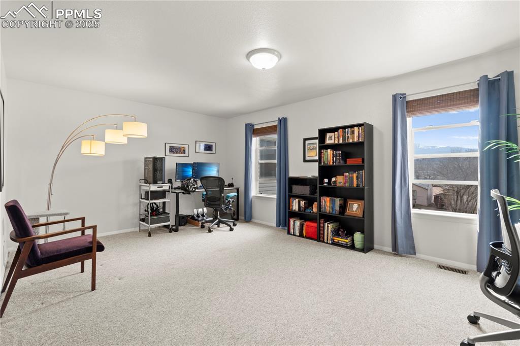 Image 14 of 40: Carpeted office space featuring visible vents and baseboards