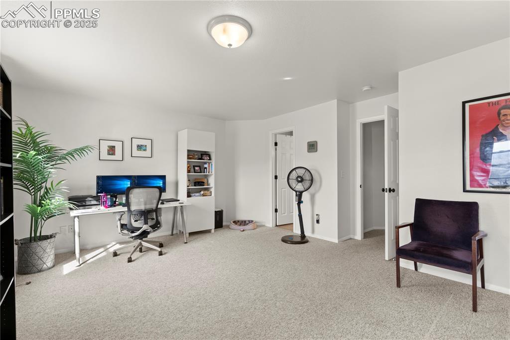 Image 16 of 40: Carpeted home office featuring baseboards