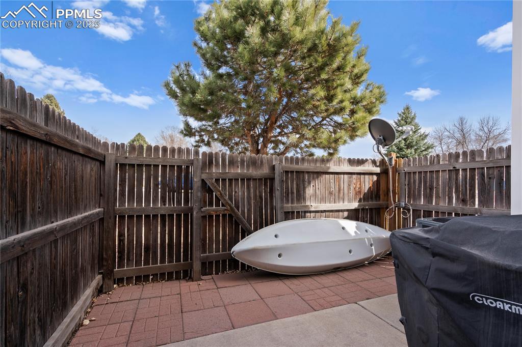 Image 23 of 40: View of patio / terrace with fence and grilling area