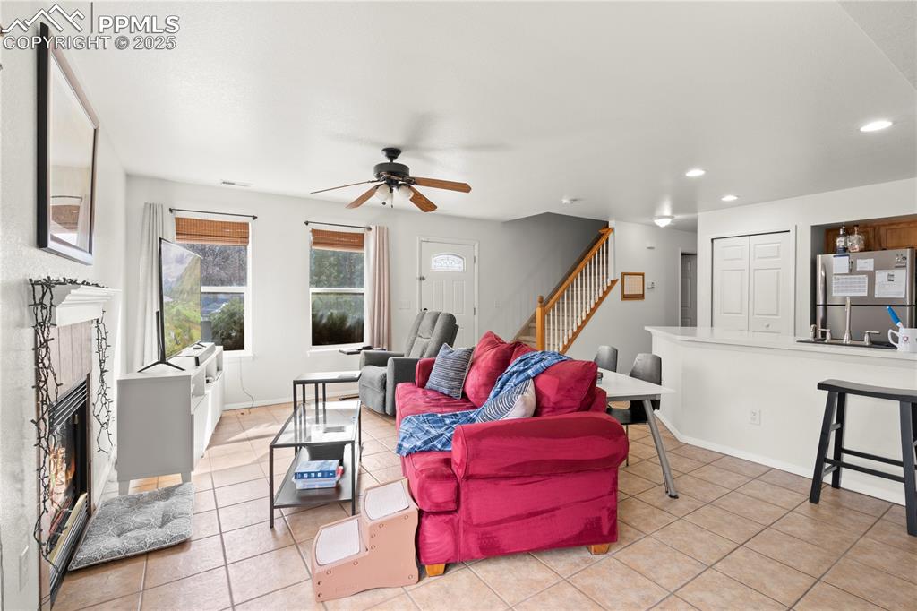Image 8 of 40: Living room with recessed lighting, light tile patterned flooring, a firepl