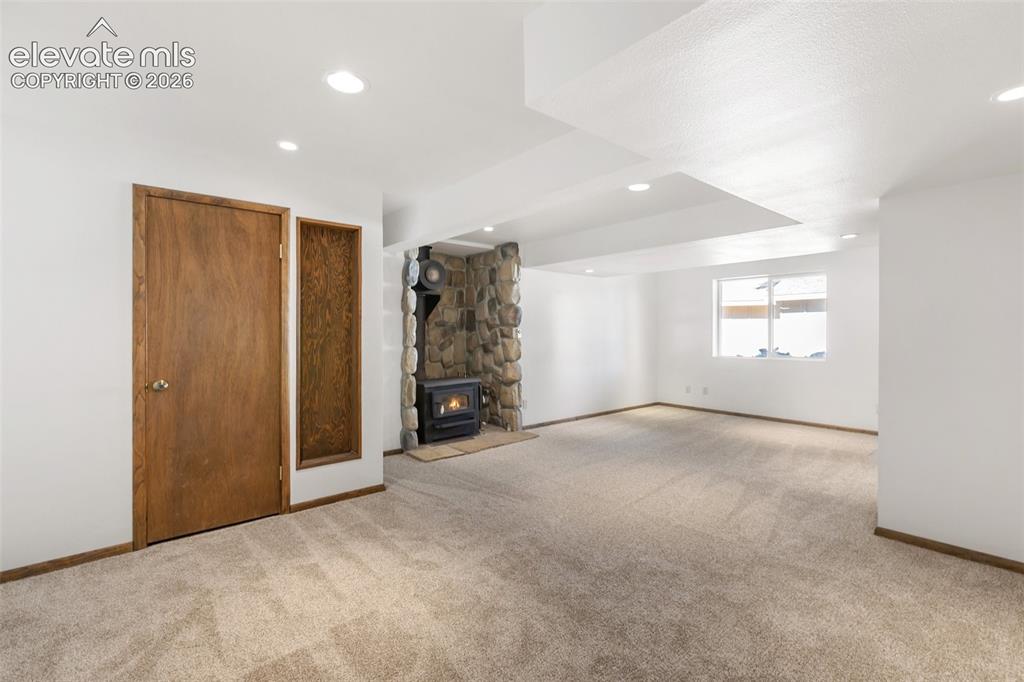 Image 15 of 50: Walk out family room with wood stove.