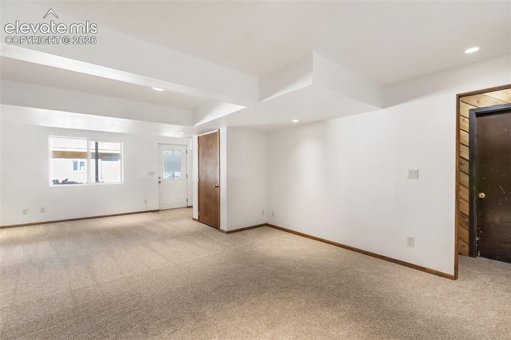Image 16 of 50: Walk out family room in basement. New carpet.