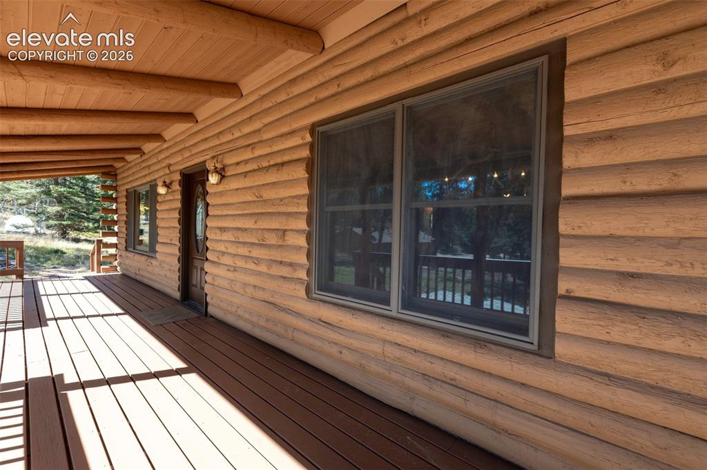 Image 18 of 50: Covered front porch. New stain.