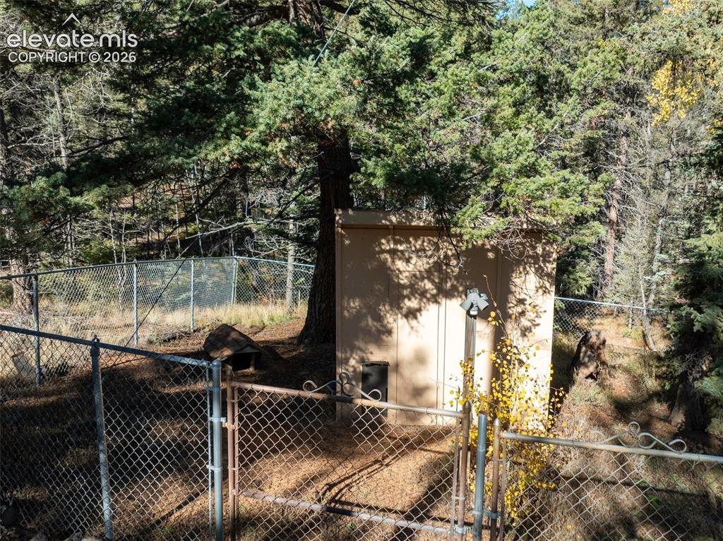 Image 20 of 50: Dog run with heated doghouse. Electric and light.
