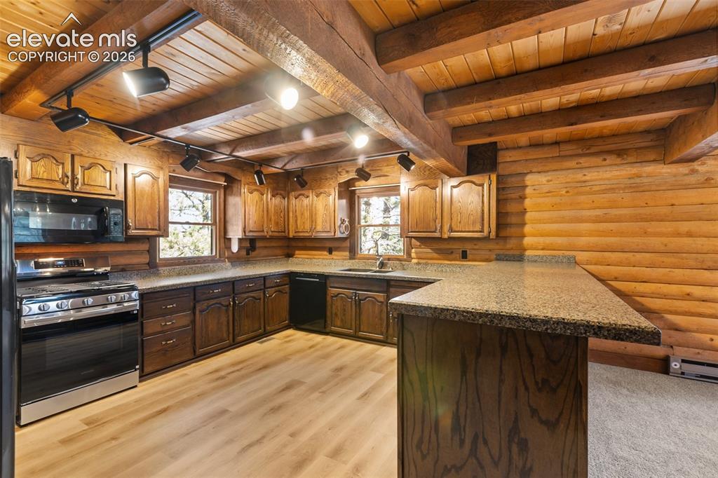 Image 21 of 50: All cabinets refinished. Huge counter area. New range and microwave. Accomm