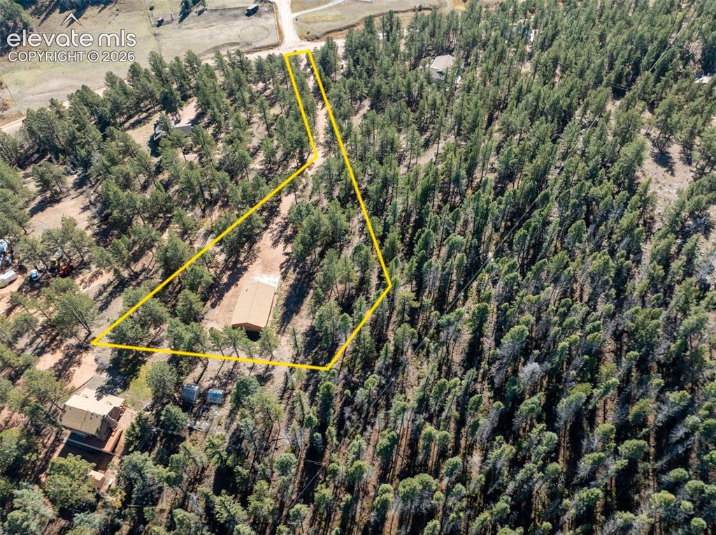 Image 42 of 50: Aerial view of included Lot 111 with 1536 sq ft workshop (2.86 acres). Prop