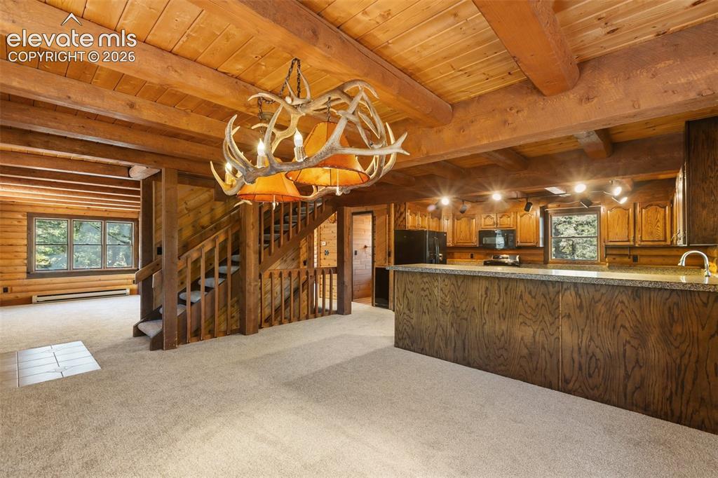 Image 8 of 50: Custom antler chandelier in dining area.