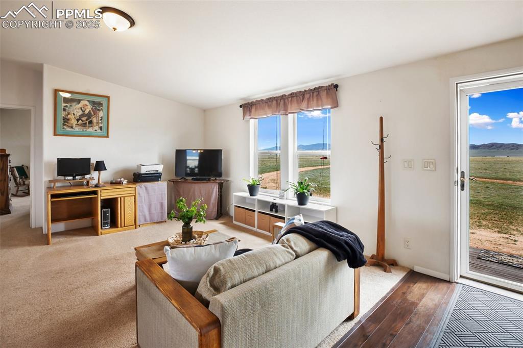 Image 10 of 49: Living area featuring an office area and wood-type flooring