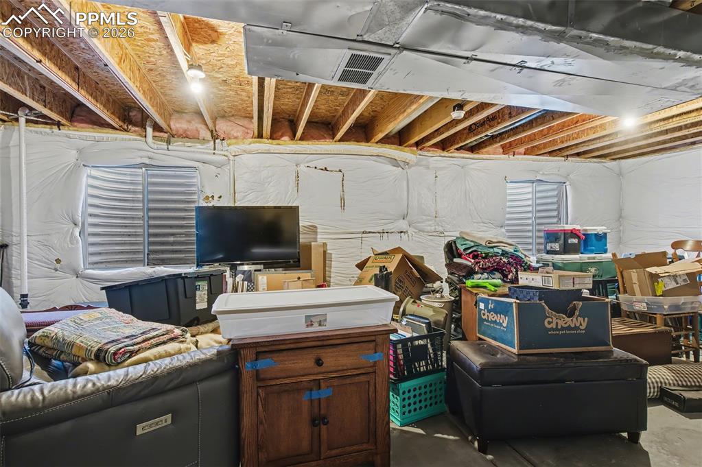 Image 22 of 24: Unfinished basement with bathroom rough-in