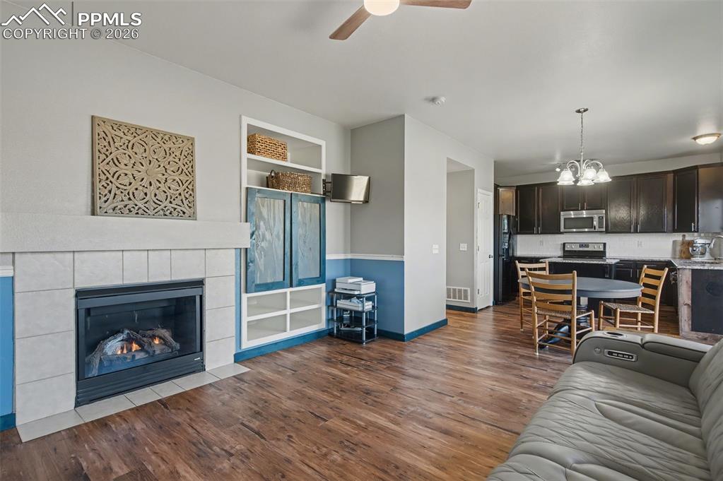 Image 9 of 24: Gas fireplace and build in cabinets