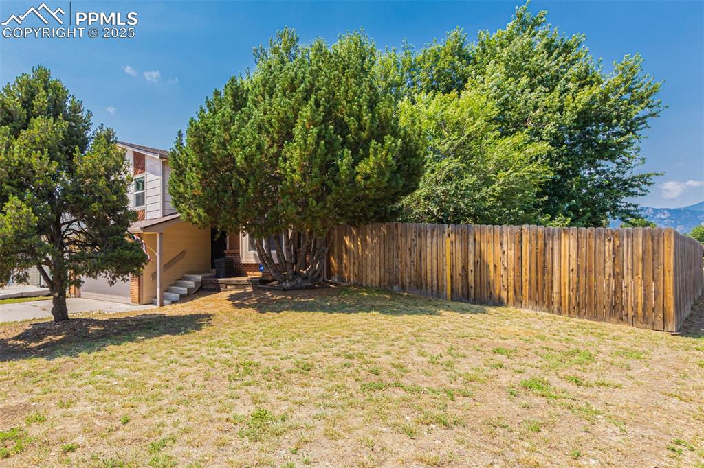 Image 38 of 43: View of yard featuring an attached garage