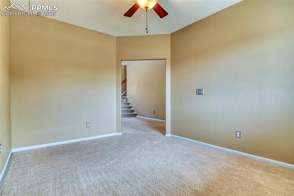 Image 10 of 49: Office, carpet, and a ceiling fan