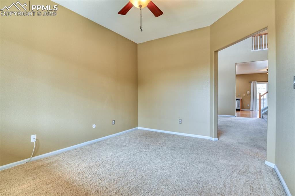 Image 11 of 49: Carpeted empty room with ceiling fan and baseboards