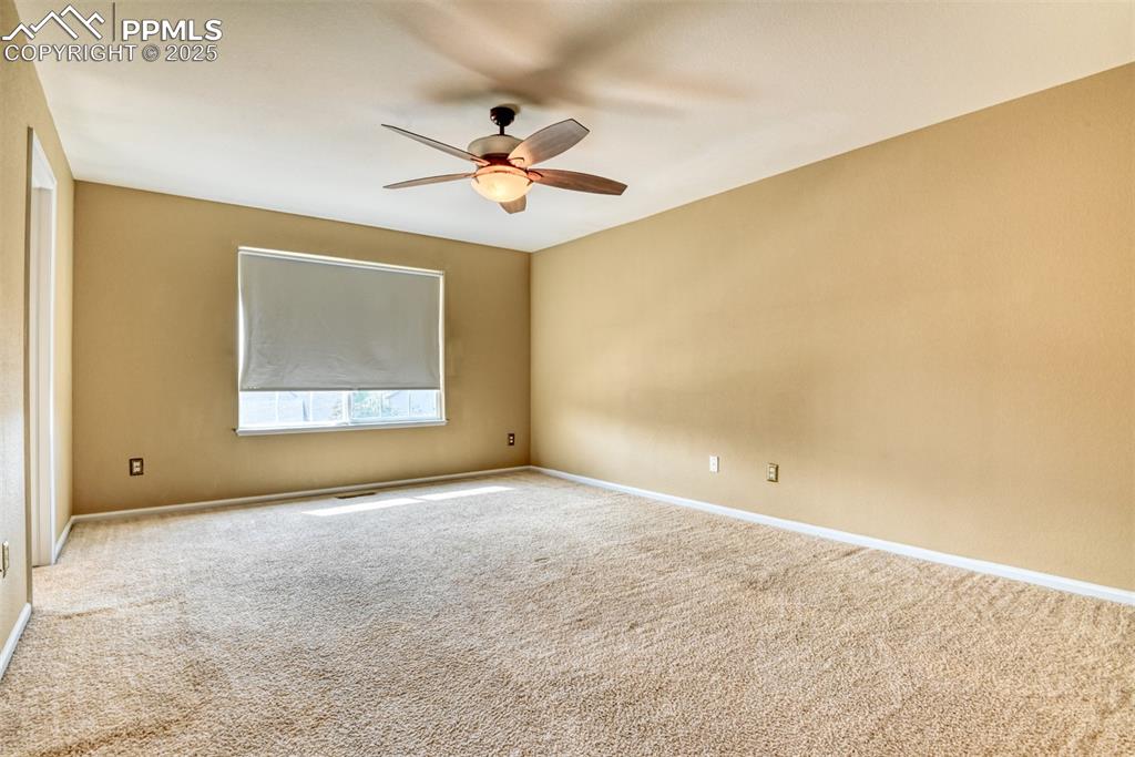 Image 25 of 49: Spare room with carpet and a ceiling fan