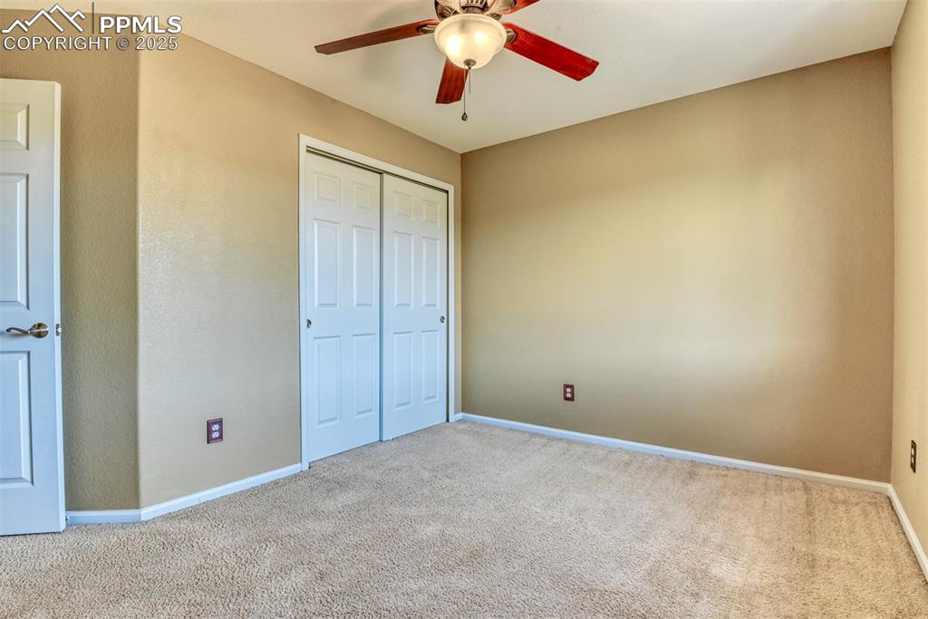 Image 36 of 49: Unfurnished bedroom featuring carpet, a ceiling fan, and a closet